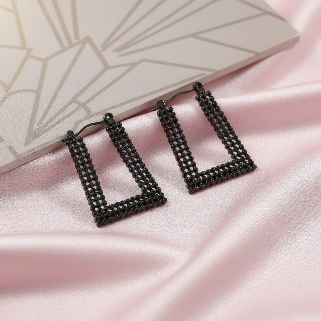 House of eLLe Always A Vibe rectangular hoop earrings in black with pavé crystal detailing on pink satin fabric.