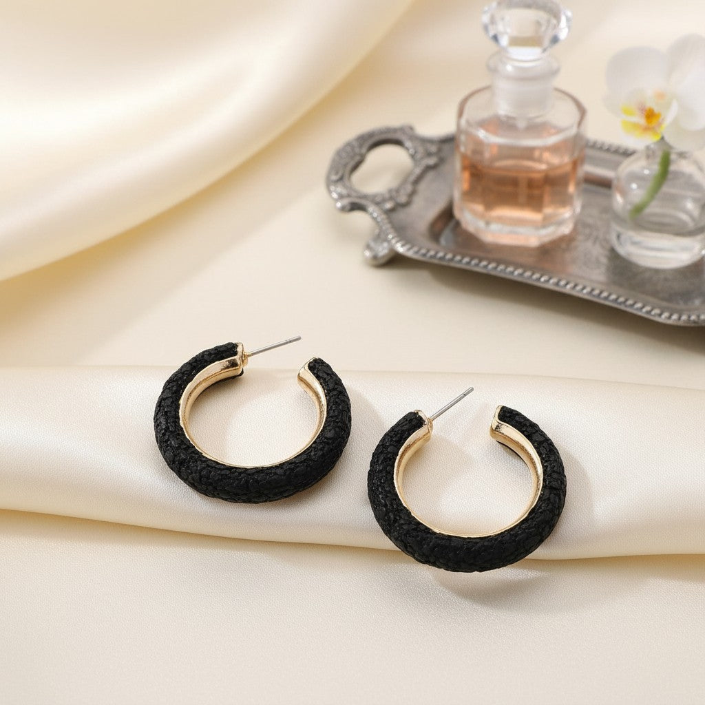 House of eLLe Party Time hoop earrings featuring black textured rhinestone detailing and gold-tone metal accents.