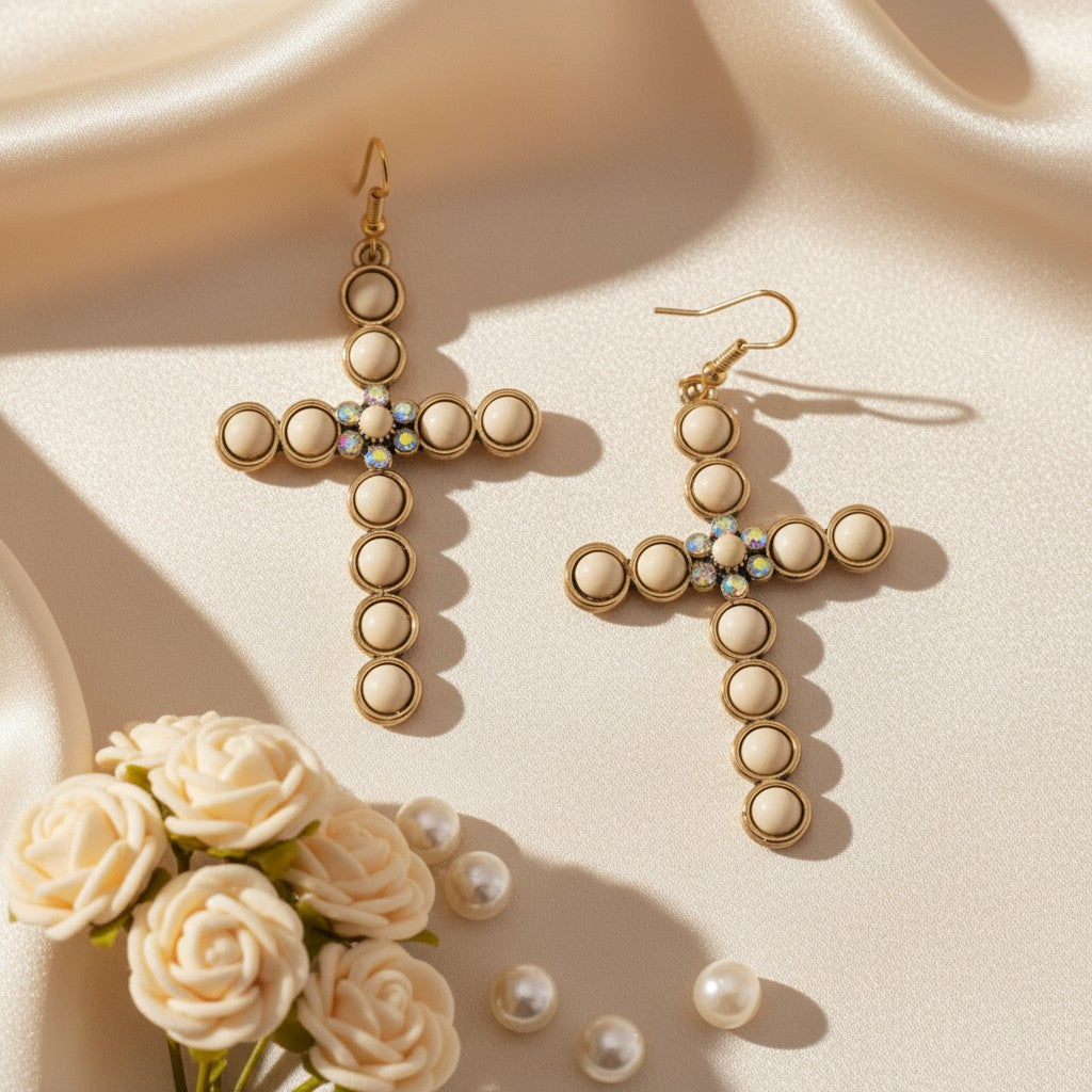 House of eLLe cream cross earrings featuring round cabochons and a central cluster of sparkling crystals.