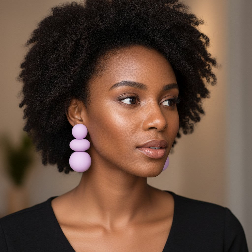 Model wearing House of eLLe I'm Flexible purple statement earrings featuring three stacked matte spheres.