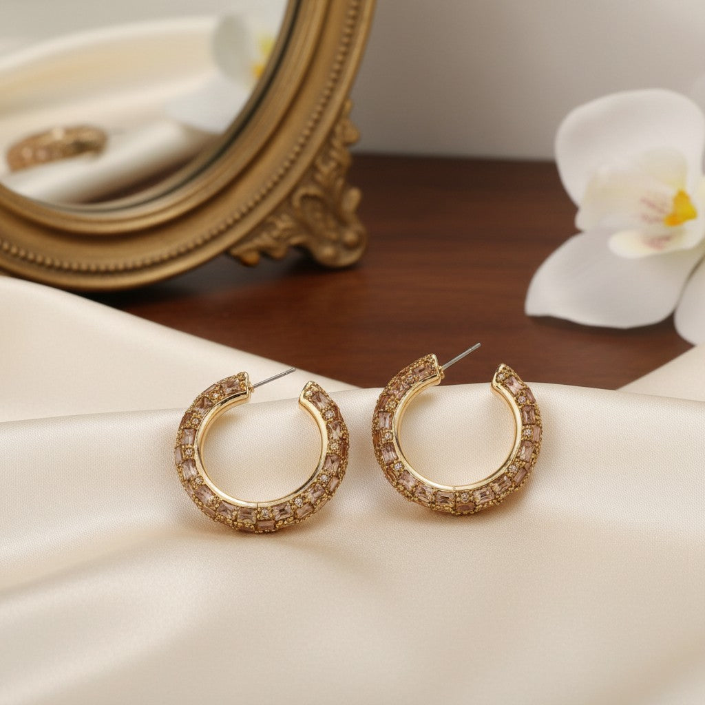 House of eLLe Life Of The Party gold hoop earrings featuring sparkling baguette and round cut crystals