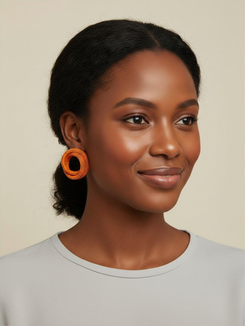 Model wearing House of eLLe Sass In The City orange circular textured statement earrings