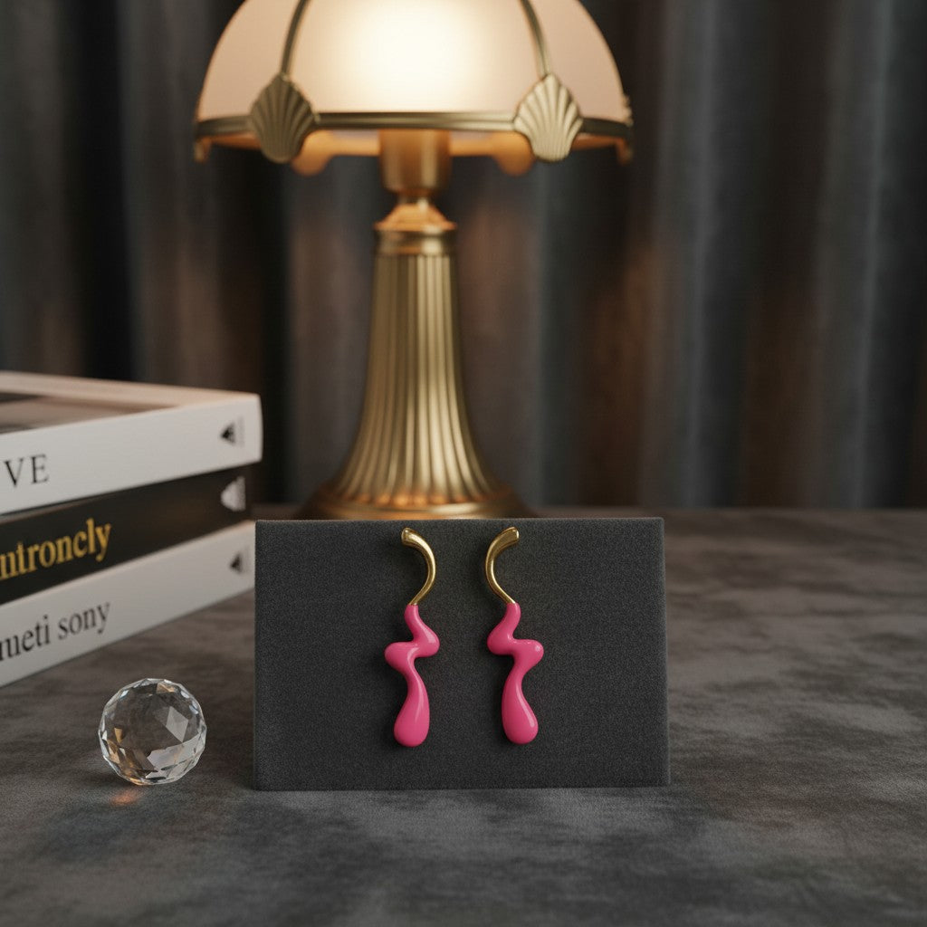 House of eLLe pink stainless-steel earrings with a unique wavy drip design displayed on a stand.