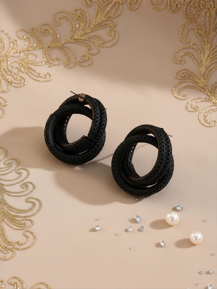 House of eLLe Sass In The City earrings featuring black textured circular hoops with a perforated design
