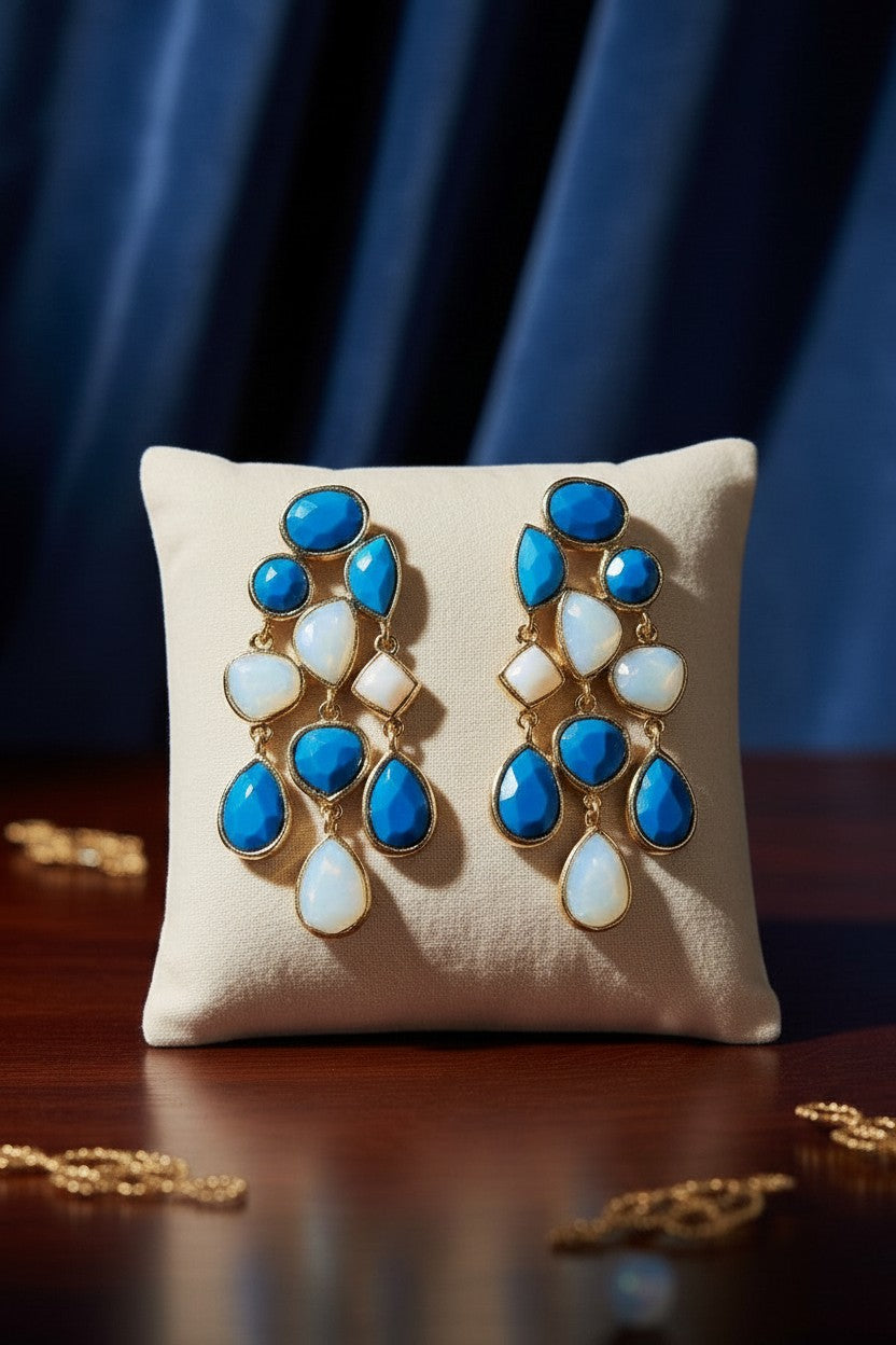 House of eLLe Crystal Dreams earrings featuring blue and iridescent teardrop stones in a gold-tone setting