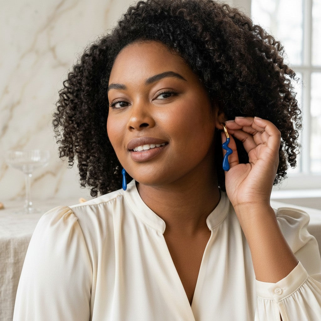 Model wearing House of eLLe blue stainless-steel Dripped In Glam earrings with a unique wavy design