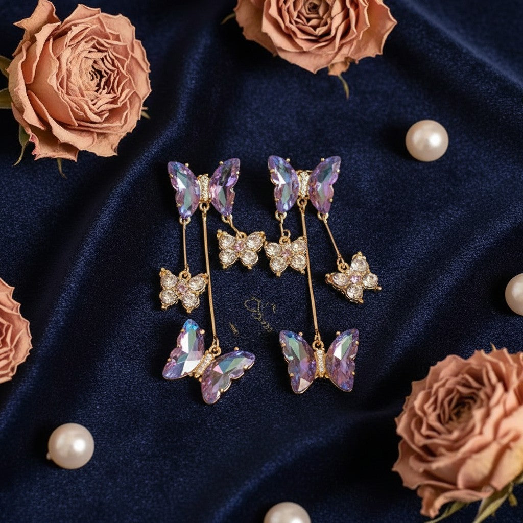 House of eLLe butterfly drop earrings with purple iridescent crystal wings and small sparkling stone accents
