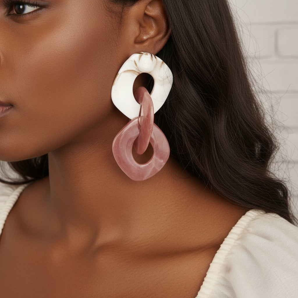 House of eLLe Never A Dull Moment earrings in brown and pink acrylic with white accents. Dangling chain link design.