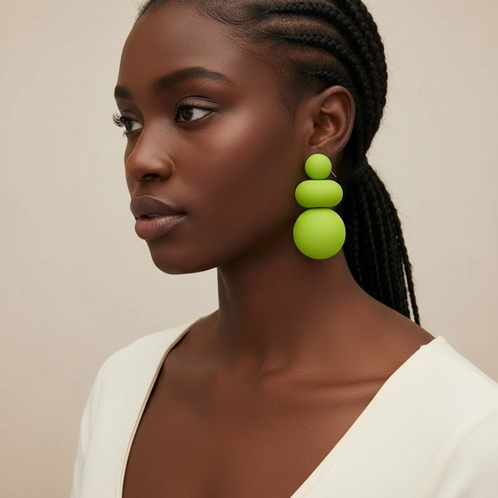 Model wearing House of eLLe I'm Flexible green statement earrings featuring stacked matte spherical shapes.