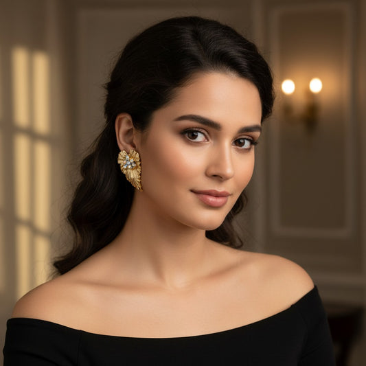 House of eLLe Bling Cluster Earrings featuring white crystals on a textured gold fan-shaped base worn by a woman.