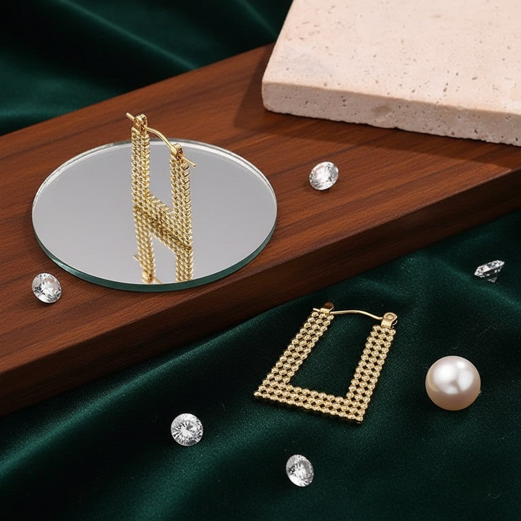 House of eLLe Always A Vibe gold rectangular hoop earrings with textured beaded detail on a dark green velvet base.