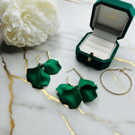House of eLLe Mini Falling For You green acrylic petal drop earrings with gold-tone hardware on a marble surface.