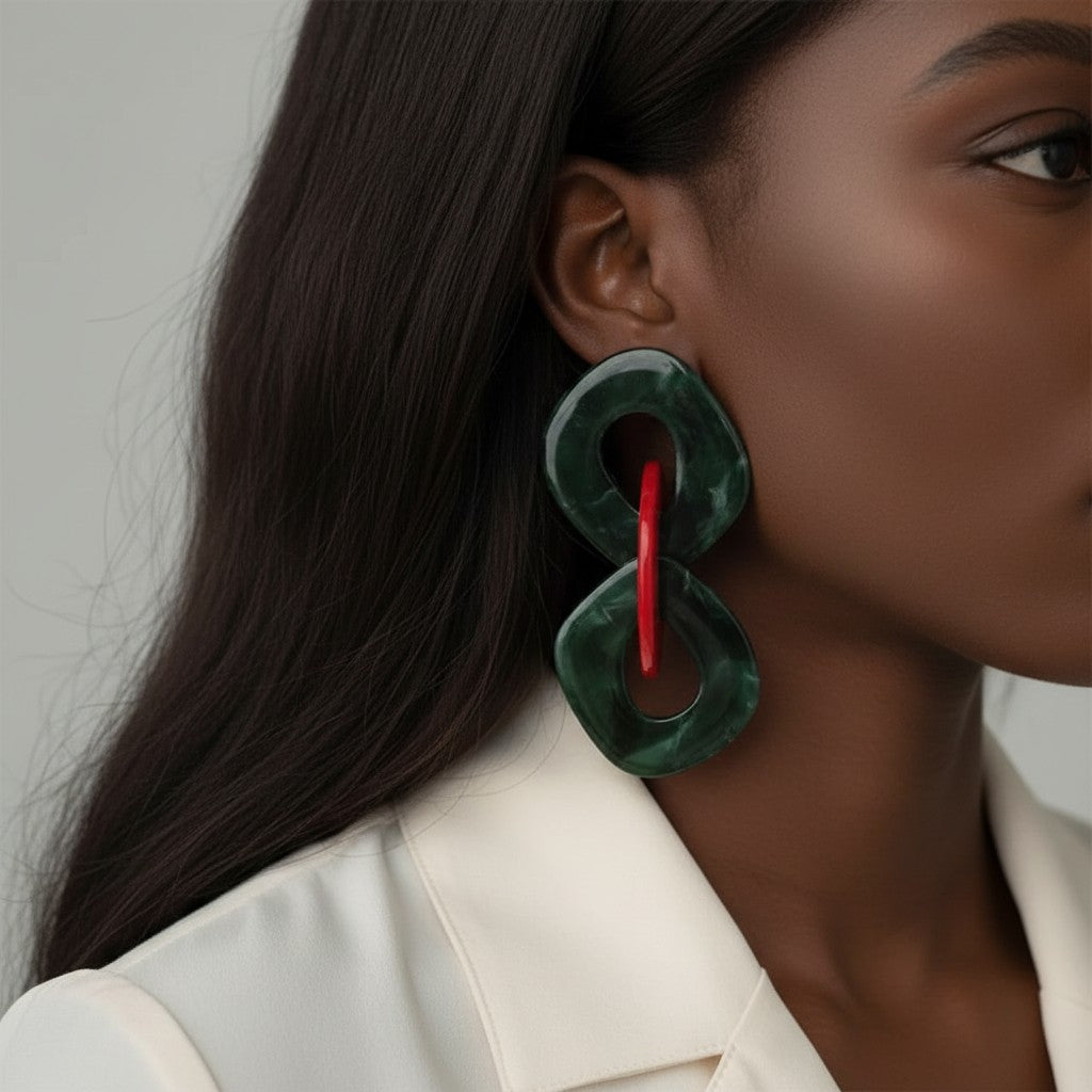 House of eLLe large statement earrings in green and red acrylic with a unique interlocking design.