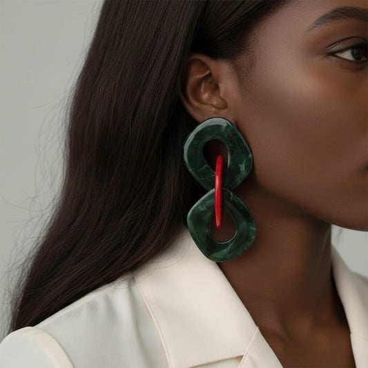 House of eLLe large statement earrings in green and red acrylic with a unique interlocking design.