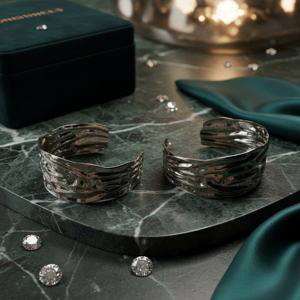 House of eLLe Larger Than Life silver earrings with a textured, organic wavy design on a green marble surface.