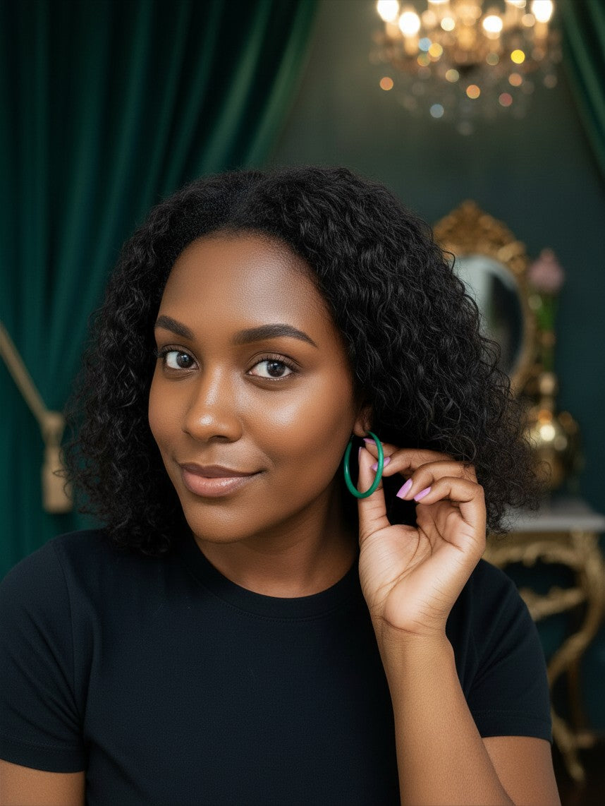 A woman wearing House of eLLe Lucky Green Hoops, featuring a minimalist circular design in a vibrant green shade.