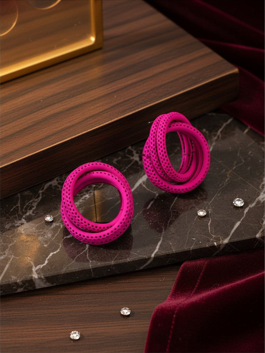 House of eLLe Sass In The City earrings in vibrant pink with a textured, perforated spiral hoop design.
