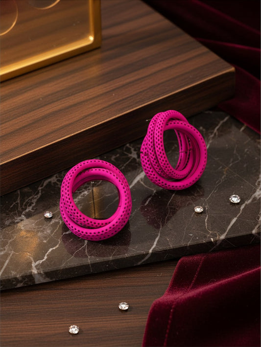 House of eLLe Sass In The City earrings in vibrant pink with a textured, perforated spiral hoop design.
