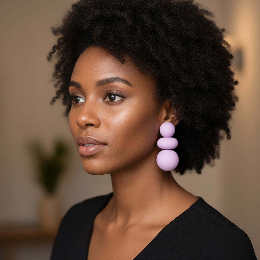 Model wearing House of eLLe I'm Flexible purple statement earrings featuring stacked matte spheres.