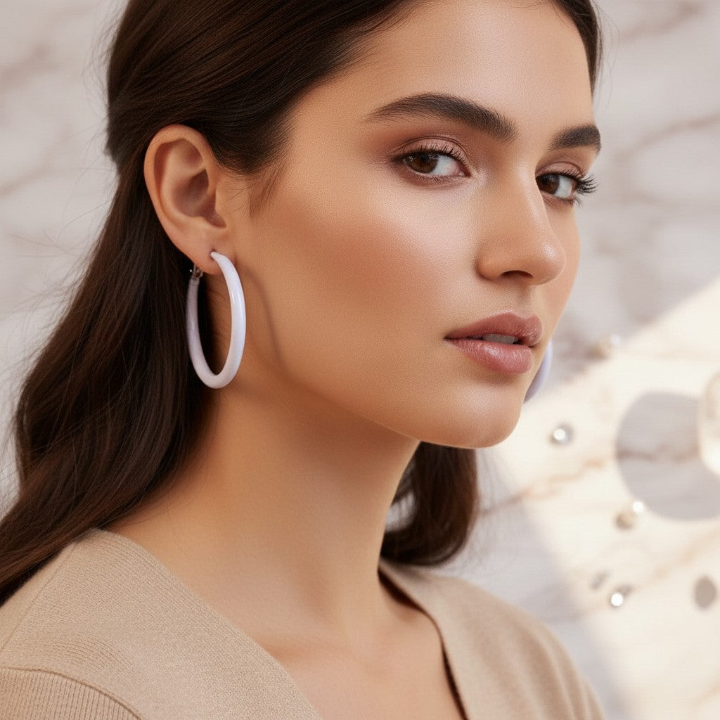 House of eLLe Springtime hoop earrings in light purple worn by a woman with dark hair