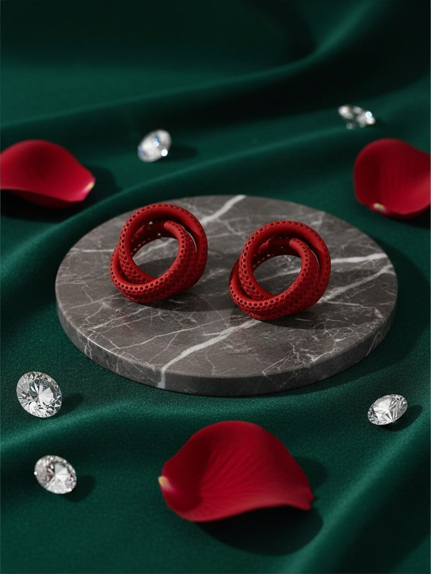 House of eLLe Sass In The City red circular earrings with a textured finish on a marble display with rose petals