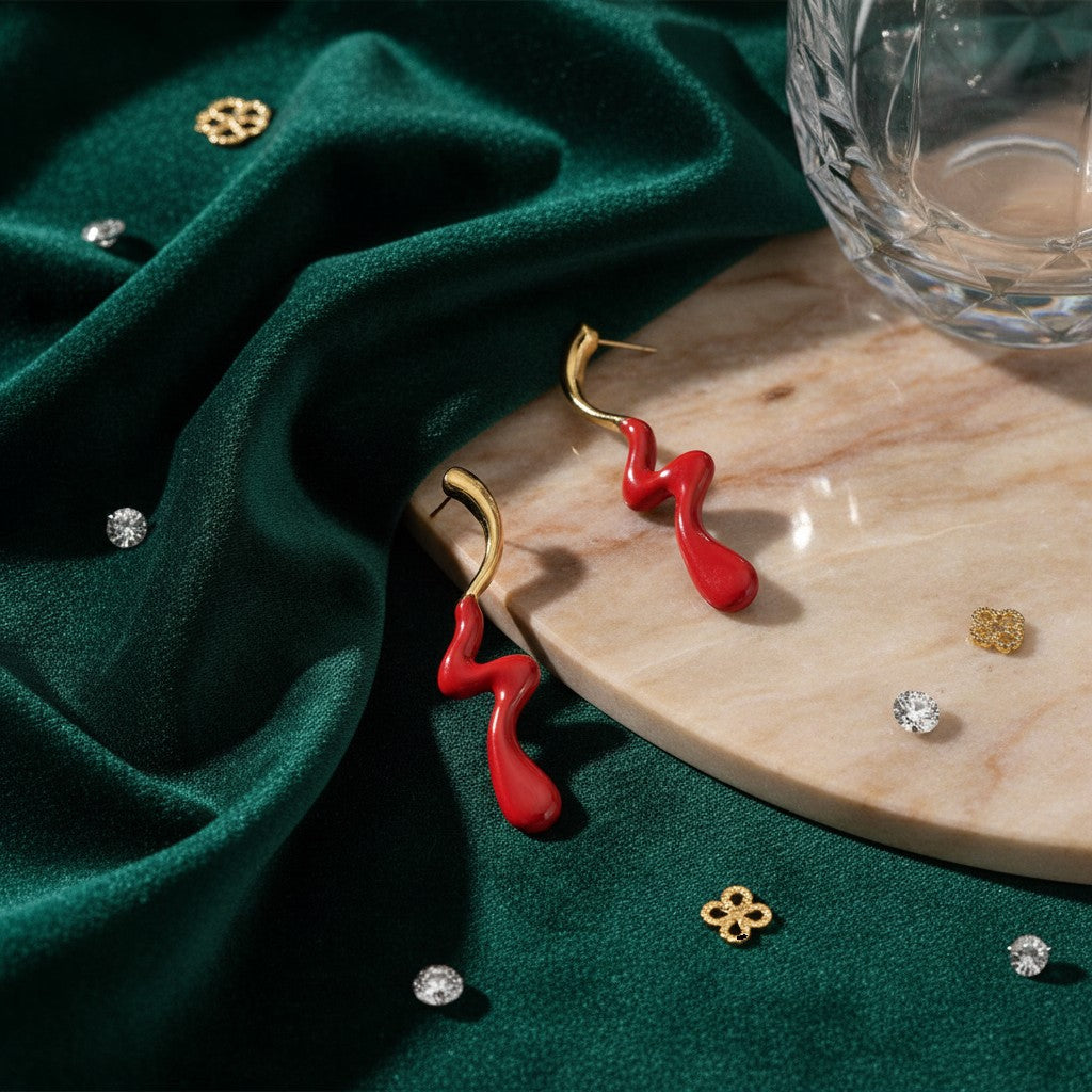 House of eLLe Dripped In Glam stainless-steel earrings featuring a wavy red enamel design on a gold-tone base.