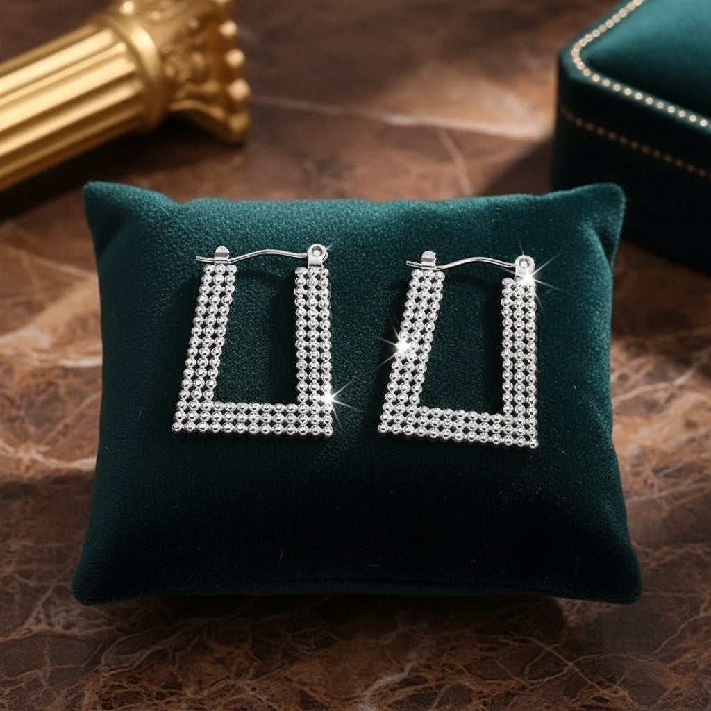 House of eLLe Always A Vibe silver rectangular hoop earrings featuring a sparkling beaded texture on a green cushion