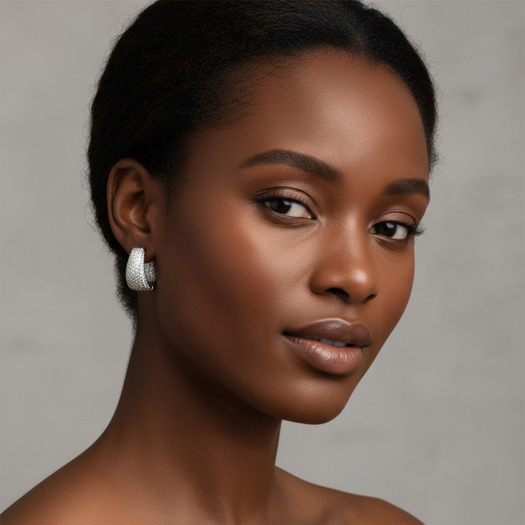 Model wearing House of eLLe Dipped In Bling silver hoop earrings encrusted with sparkling white diamonds.