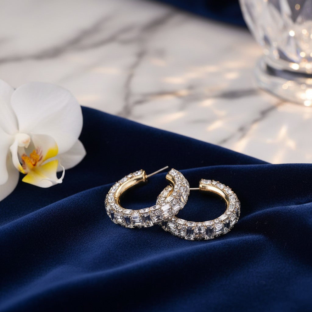 House of eLLe Life Of The Party silver iridescent hoop earrings with baguette crystals on blue velvet fabric