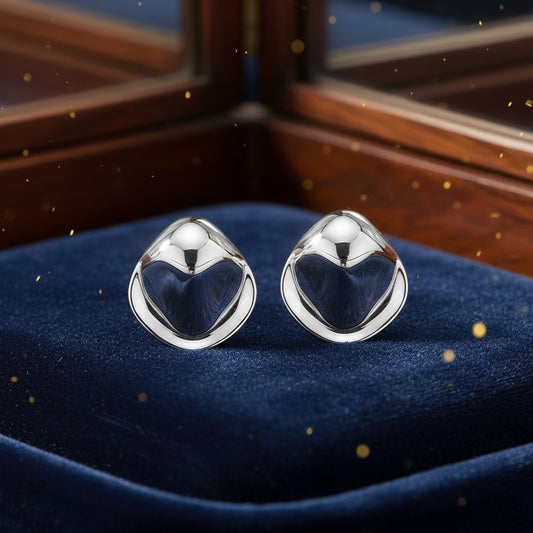 House of eLLe I'm So Serious silver stud earrings with a smooth, sculptural, teardrop-inspired shape on blue velvet.