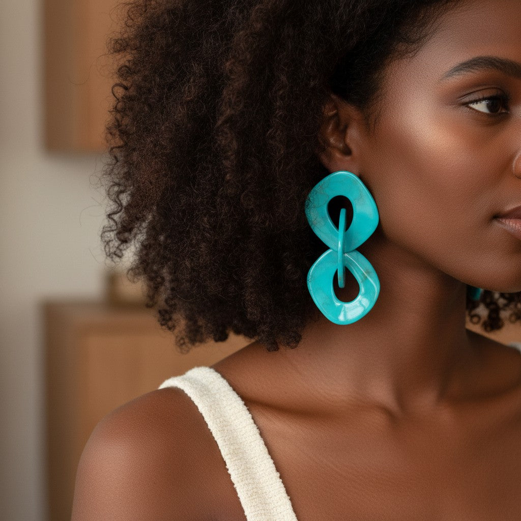 House of eLLe teal acrylic statement earrings with geometric shapes and a double-drop design.
