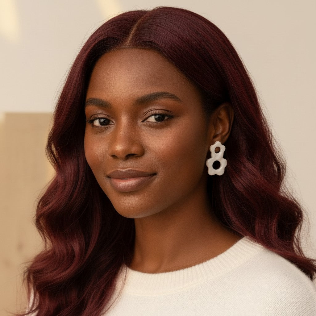 House of eLLe Flow Vibes earrings in white stainless steel worn by a woman with long wavy burgundy hair