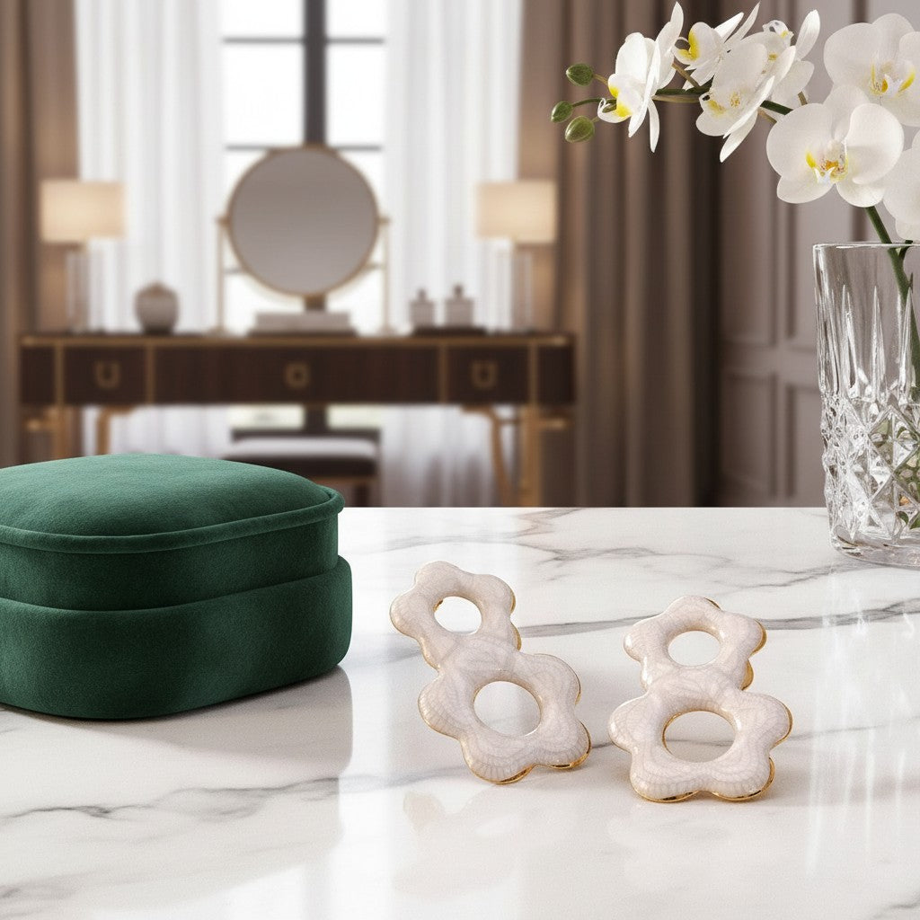 House of eLLe Flow Vibes earrings in white stainless steel with a unique flower-shaped design on a marble table.